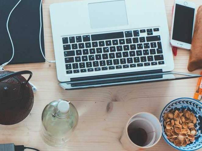 Top view of laptop,snacks, and coffee