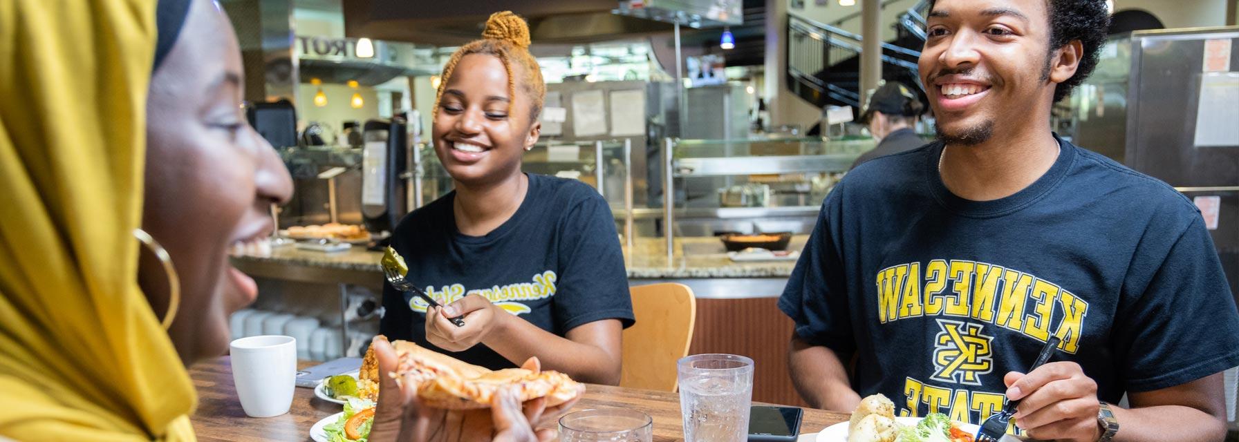 Residential students sitting at a table in the dining hall